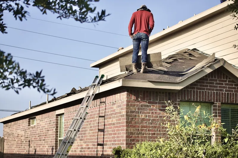 Professional roofer working on a residential roof in Prospect Park